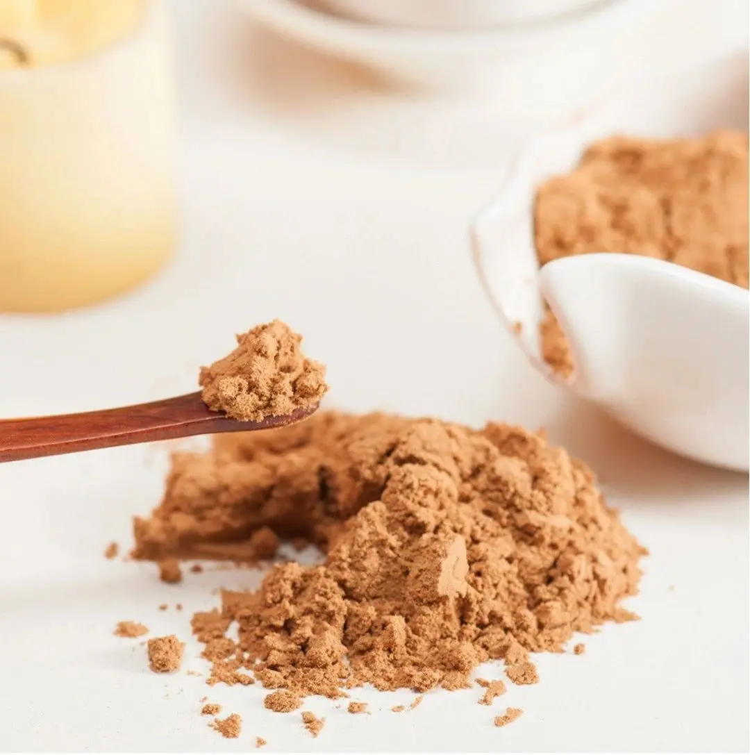 Brown powder on wooden spoon