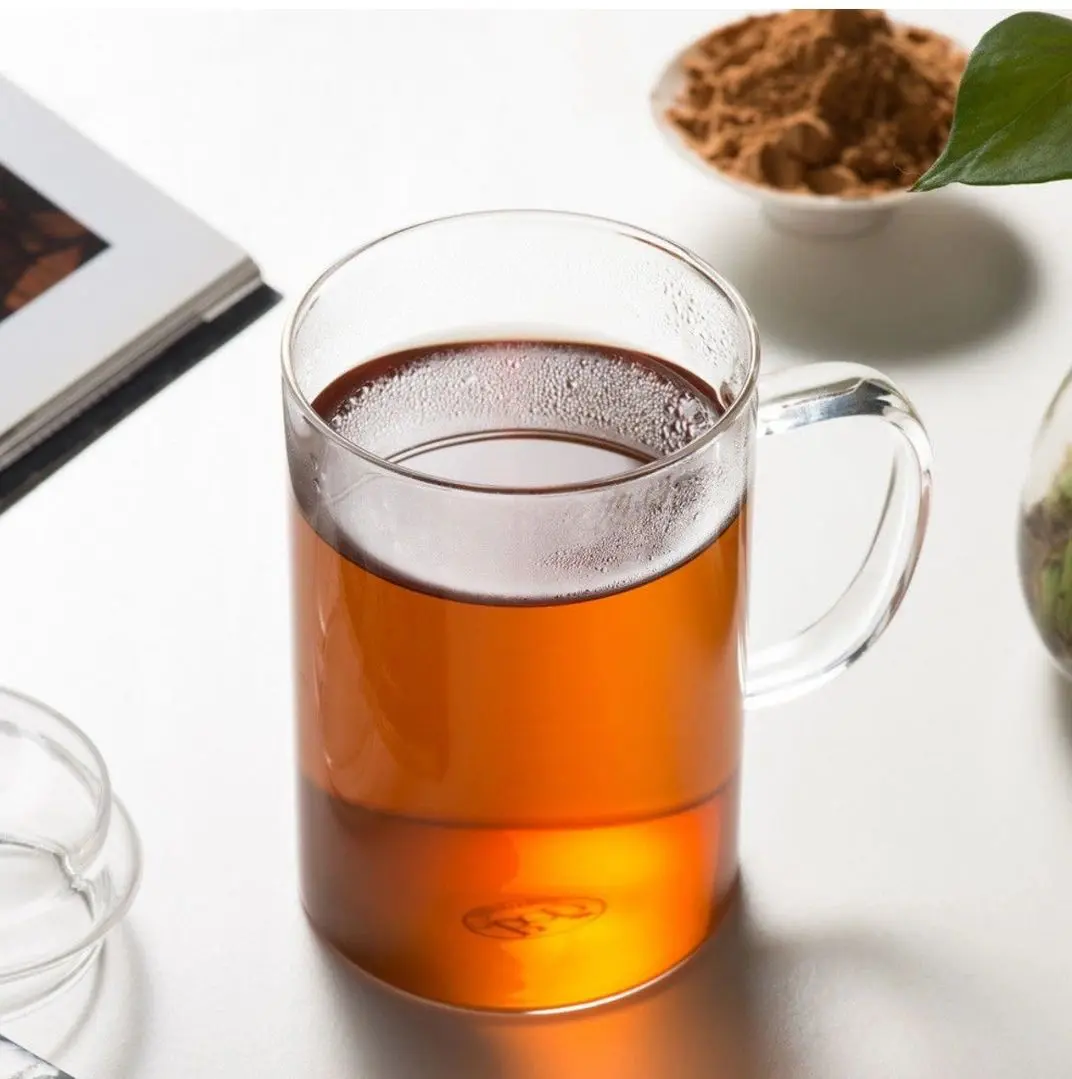 Glass mug of tea on table